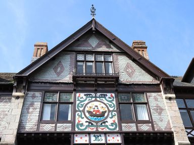 Building facade with decorative panel and windows at Dart Views in Dartmouth