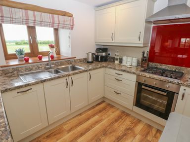 A kitchen with a sink and cupboards at The Gallops in Barry