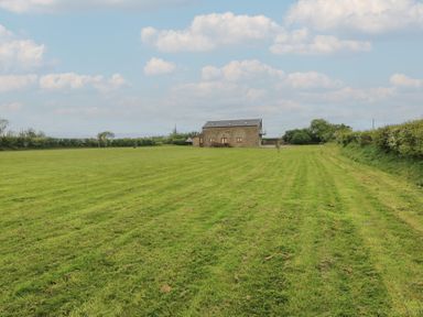 A house surrounded by a field at The Gallops in Barry