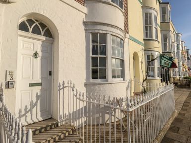 A front entrance with a white door and windows at Number 3 by the Sea in Weymouth