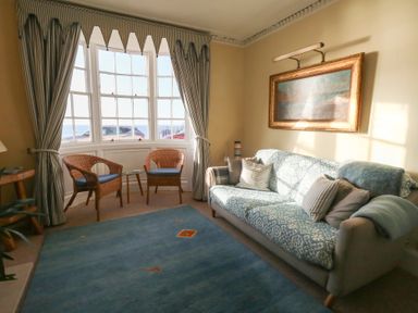 A living room with a sofa and armchairs at Number 3 by the Sea in Weymouth