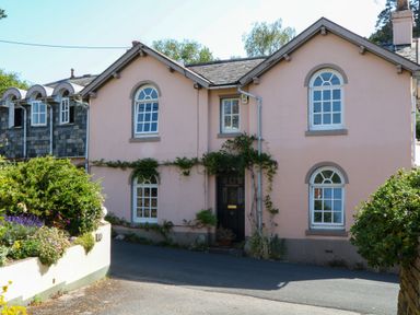 A building with windows, plants and a door at Gorway Cottage in Teignmouth