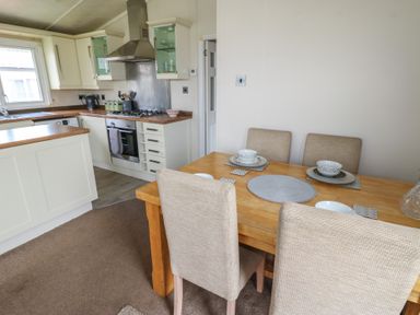 A kitchen with a dining table and chairs at Plot 34 near Armathwaite