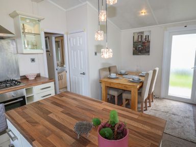 A kitchen with a dining table and chairs at Plot 34 near Armathwaite