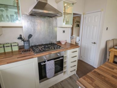 A kitchen with a gas stove and wooden countertops at Plot 34 near Armathwaite
