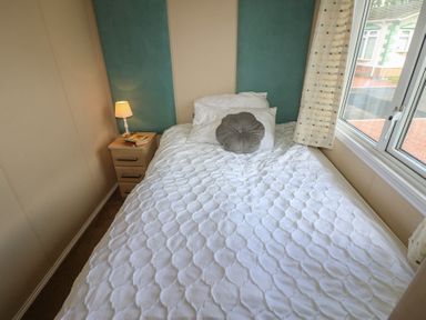 A bedroom with a bed and nightstand at Plot 34 near Armathwaite