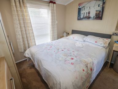 A bedroom with a bed and curtains at Plot 34 near Armathwaite