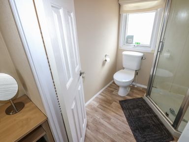 A bathroom with a toilet and shower at Plot 34 near Armathwaite