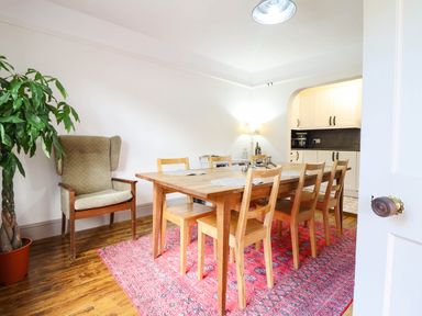A dining room with a wooden table and chairs at Hafanedd in Betws-y-Coed