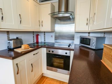 A kitchen with appliances and countertop at Little Gem in Weymouth