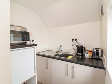 A kitchen with a sink and appliances at Coach House Highampton near Black Torrington