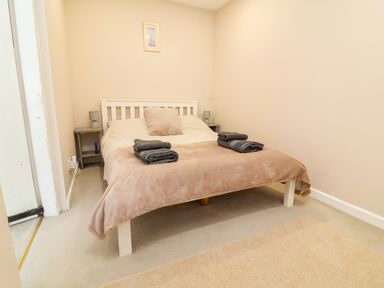 A bedroom with a bed and bedside table at Coach House Highampton near Black Torrington