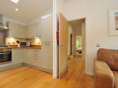 A kitchen with a door leading to other rooms at 11 Water's Edge near Pelynt