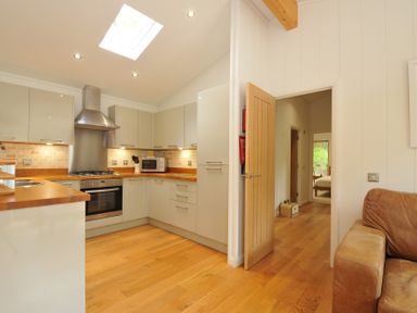 A kitchen with cabinets and countertops at 11 Water's Edge near Pelynt