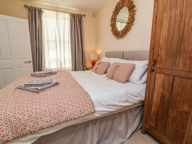 A bedroom with a bed and wardrobe at Sea Vista in Westward Ho!