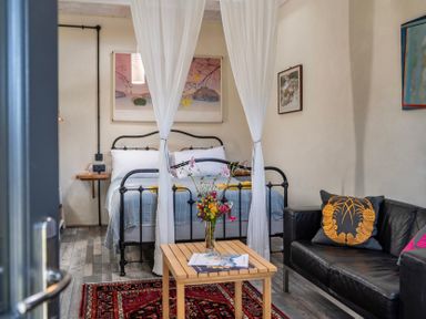 A bedroom with a bed and seating area at Little Linney Sleeps 2 Garden Parking Wifi Hartland