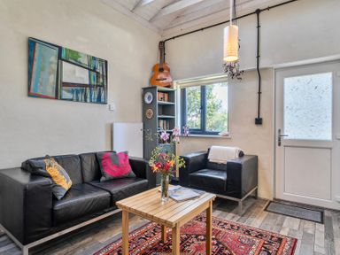 A living room with a sofa, chairs, and a table at Little Linney Sleeps 2 Garden  Parking  Wifi Hartland