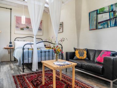 A bedroom with a bed and a sofa at Little Linney Sleeps 2 Garden Parking Wifi in Hartland