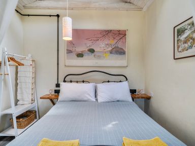 A bedroom with a bed and artwork on the wall at Little Linney Sleeps 2 Garden  Parking  Wifi Hartland