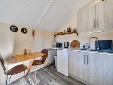 A kitchen with a table and chairs at Little Linney Sleeps 2 Garden  Parking  Wifi in Hartland