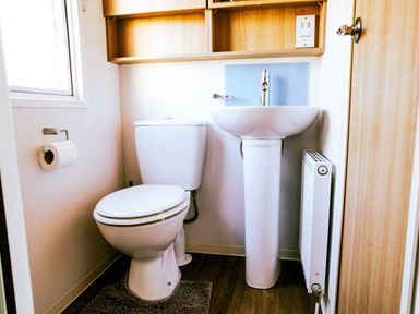 A bathroom with a toilet and sink at Captivating 6-Person Caravan in Rhyl