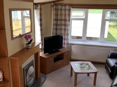 A living room with a television and fireplace at Static Caravan 2 Bedrooms - sleeps 4 Hawick