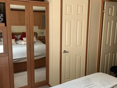 A bedroom with a bed and wardrobe at Static Caravan 2 Bedrooms - sleeps 4 in Hawick