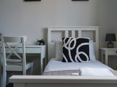 A bedroom with a bed, desk, chair, and lamp at Lily Apartment - Sleeps 3 - Pet friendly - Parking, Bedlington