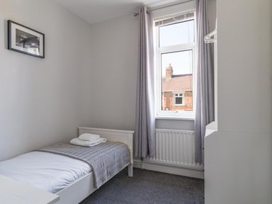 A bedroom with a bed and window at Lily Apartment - Sleeps 3 - Pet friendly - Parking in Bedlington