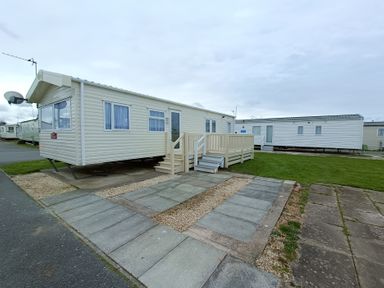 A mobile home with steps and a satellite dish at 3 Bed, Sleeps 6, Parking
