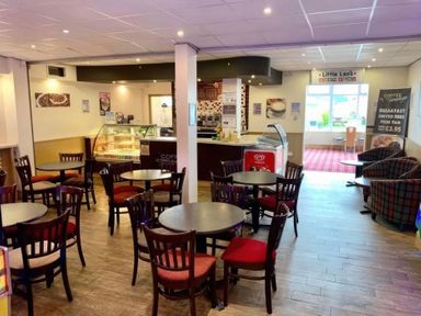A cafe with tables and chairs at Little Leo's