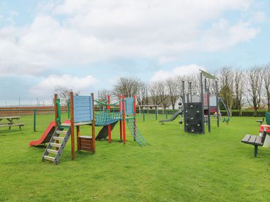 A playground with climbing frames and slides at The Dorchester at Bay View, Maen-y-groes near New Quay