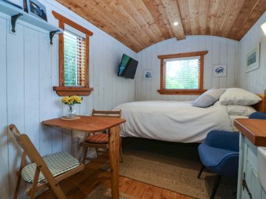 A bedroom with a bed and a table at Ardwyn in Pwllheli