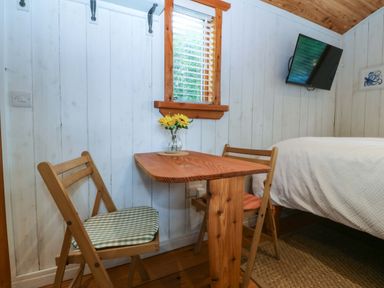 A bedroom with a table and chairs at Ardwyn in Pwllheli