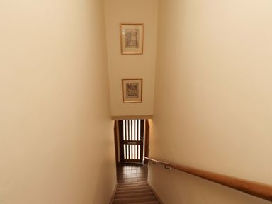 A staircase leading to a door at Sarah's Cottage