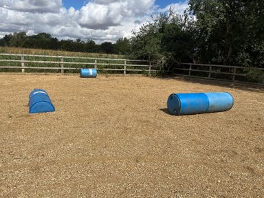 An outdoor area with blue barrels and gravel at Laurel in Littleport