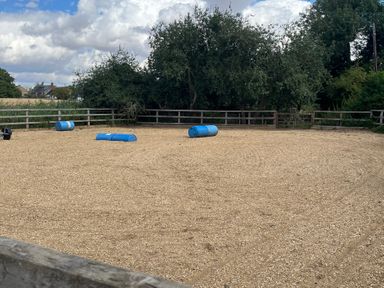 An outdoor equestrian area with barrels and a fence at Laurel in Littleport