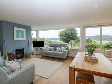 A living room with a sofa and a coffee table at Red Wharf Retreat near Red Wharf Bay