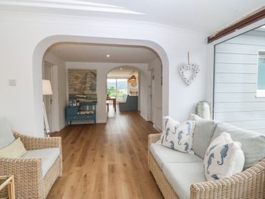 A living room with a sofa and armchair at Red Wharf Retreat near Red Wharf Bay