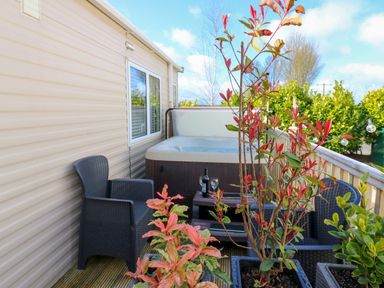 An outdoor area with a hot tub and seating at Plot 41 High Hesket near Armathwaite