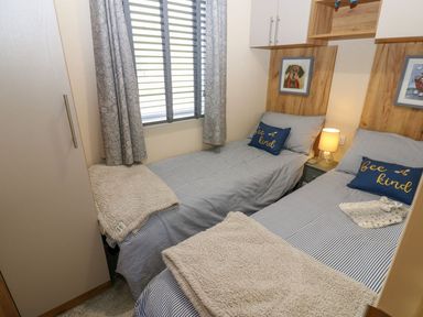 A bedroom with two single beds and wardrobe at Plot 41 High Hesket near Armathwaite