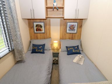 A bedroom with two beds and wall art at Plot 41 High Hesket near Armathwaite