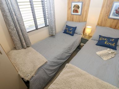 A bedroom with two beds and wall art at Plot 41 High Hesket near Armathwaite