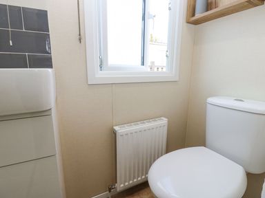 A bathroom with a toilet and sink at Plot 41 High Hesket near Armathwaite