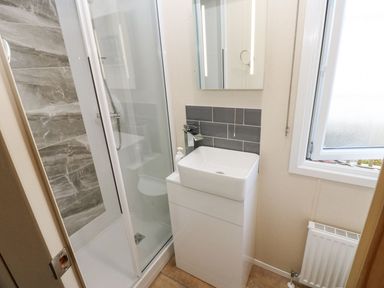 A bathroom with a shower and sink at Plot 41 High Hesket near Armathwaite