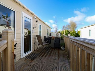 An outdoor area with seating and a planter at Plot 41 in High Hesket near Armathwaite