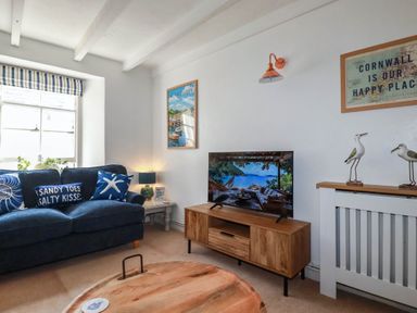 A living room with a tv and sofa at Stones Throw in Mevagissey