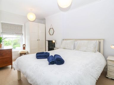 A bedroom with a double bed and a window at Llys Awen in Caernarfon