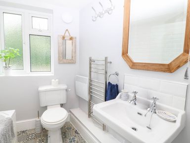 A bathroom with a toilet and sink at Llys Awen in Caernarfon