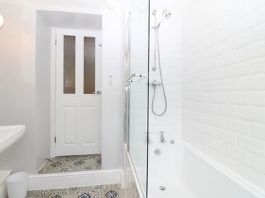 A bathroom with a shower and bathtub at Llys Awen Caernarfon